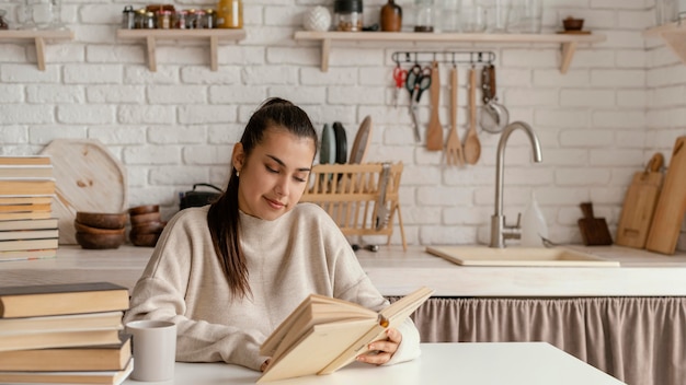 Medium shot smiley woman reading