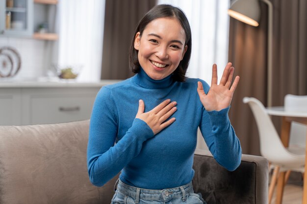 Medium shot smiley woman saluting