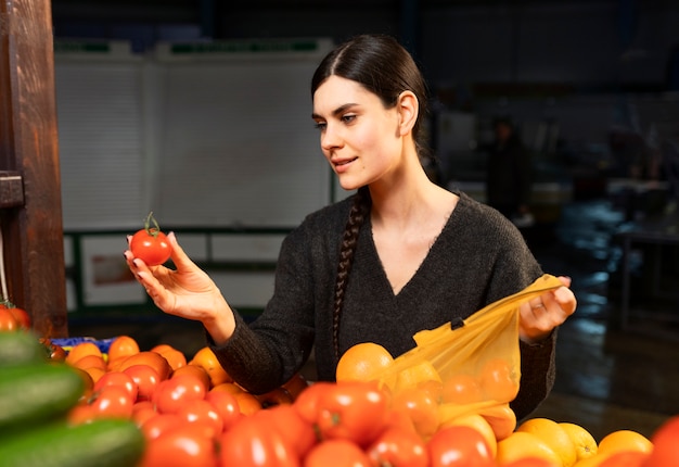 Free photo medium shot smiley woman shopping at market