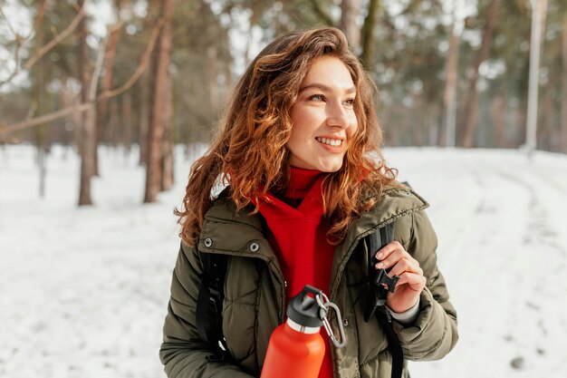 Medium shot smiley woman in snow