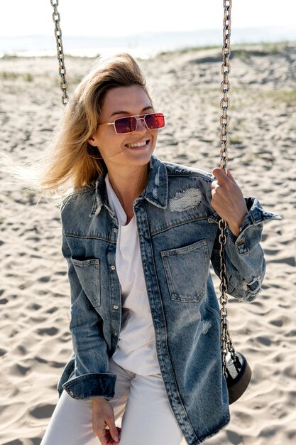 Medium shot smiley woman on swing