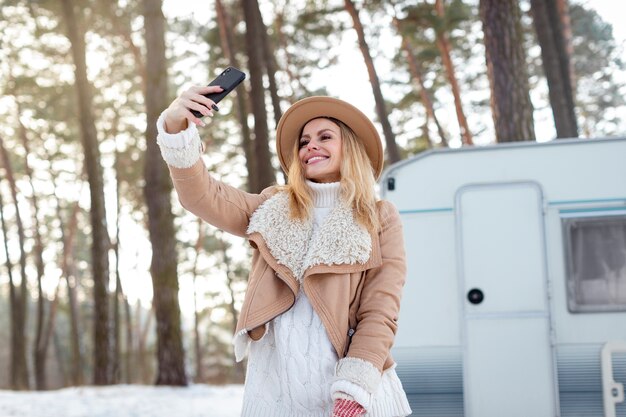 Medium shot smiley woman taking selfie