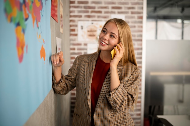 Medium shot smiley woman talking on phone