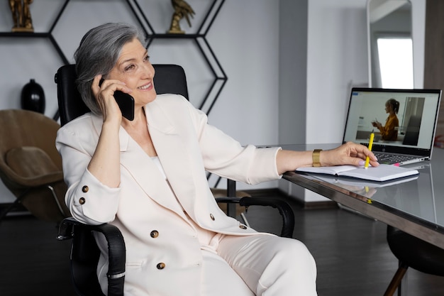 Medium shot smiley woman talking on phone