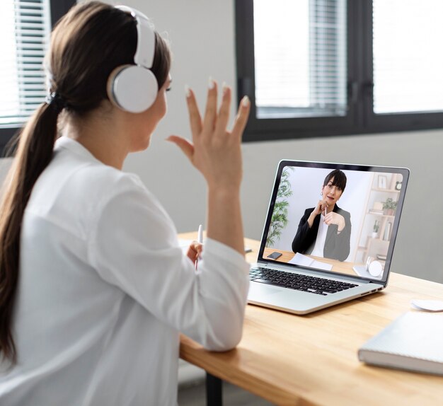 Medium shot smiley woman in video call