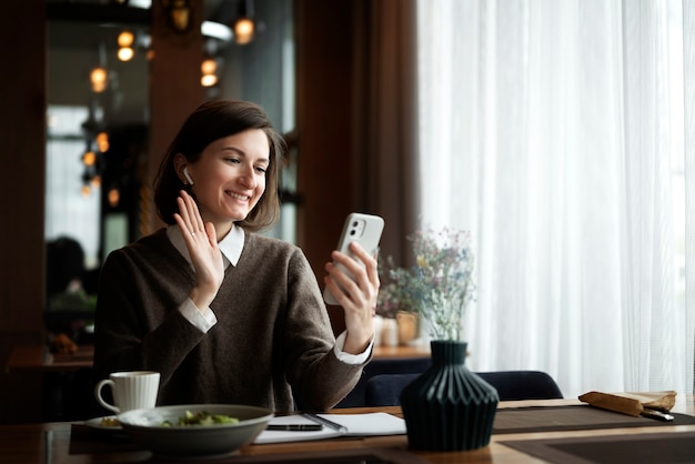 Medium shot smiley woman video call