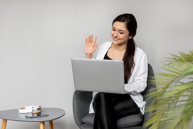 Free Photo medium shot smiley woman waving