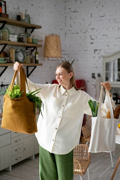 Medium shot smiley woman with bags