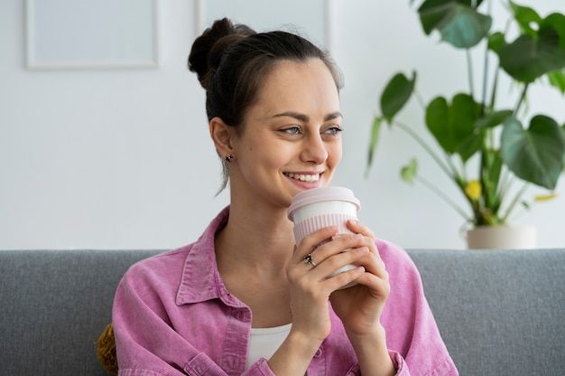 Medium shot smiley woman with coffee cup