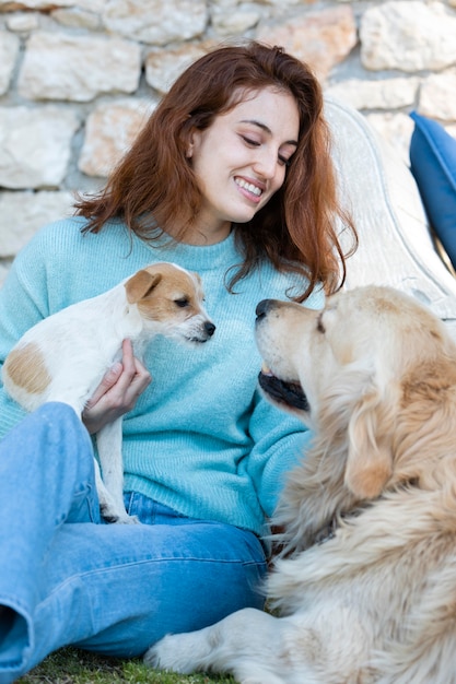 Medium shot smiley woman with cute dogs