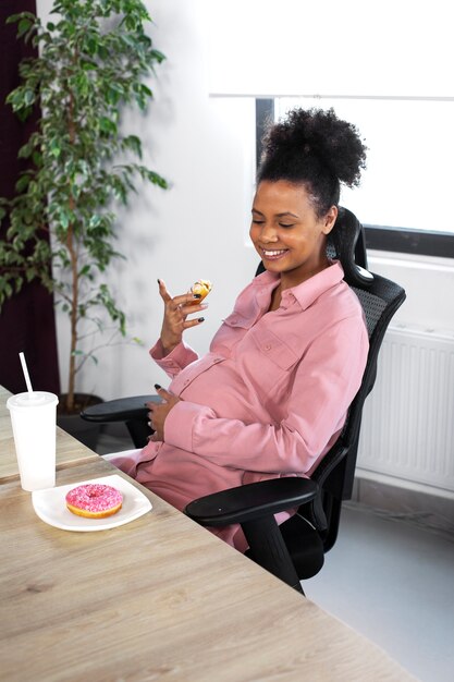 Medium shot smiley woman with doughnut