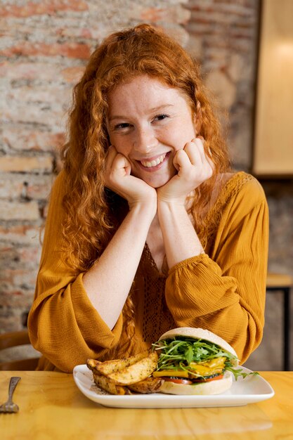 Medium shot smiley woman with food