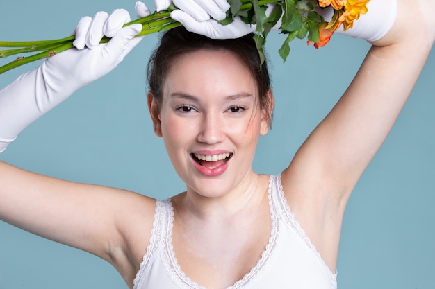 Medium shot smiley woman with gloves and flowers