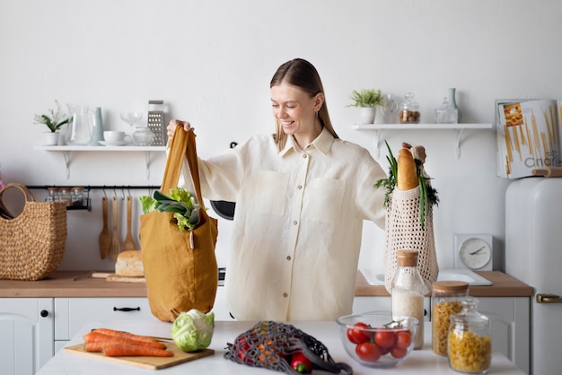 Free Photo medium shot smiley woman with groceries