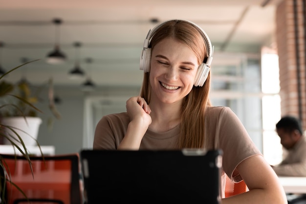 Medium shot smiley woman with headphones