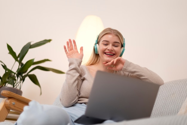 Medium shot smiley woman with headphones