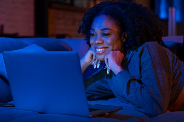 Medium shot smiley woman with laptop