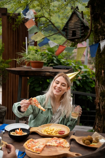 Free Photo medium shot smiley woman with pizza