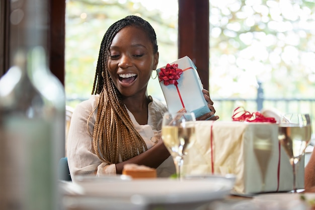 Medium shot smiley woman with present