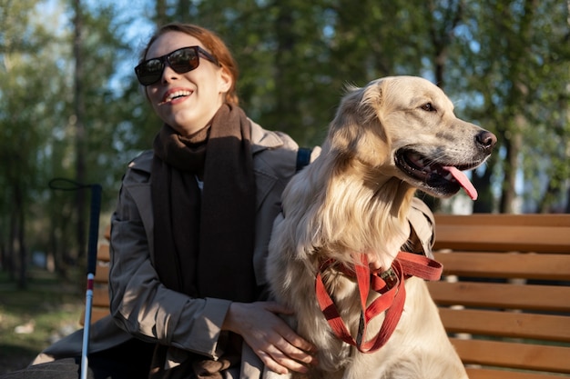 Free Photo medium shot smiley woman with service dog