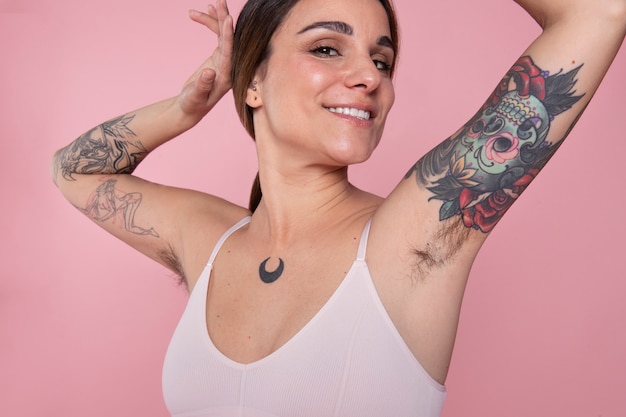 Medium shot smiley woman with tattoos