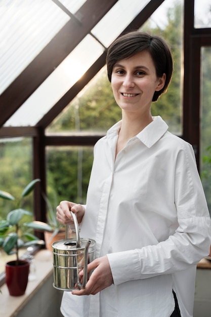 Medium shot smiley woman with watering can