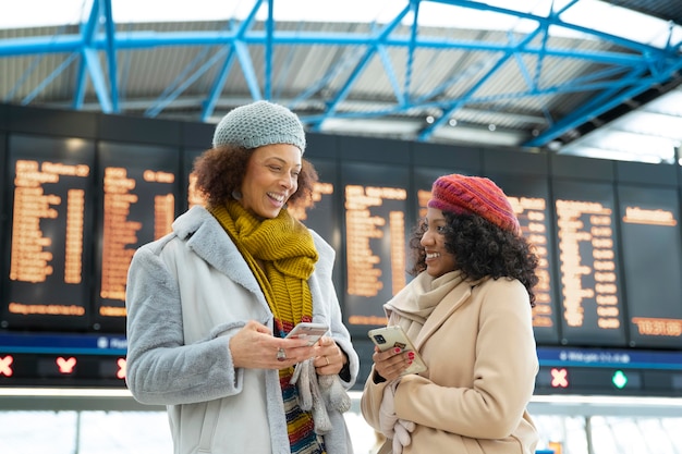 Medium shot smiley women at airport