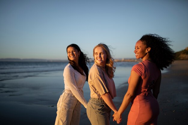 Medium shot smiley women holding hands