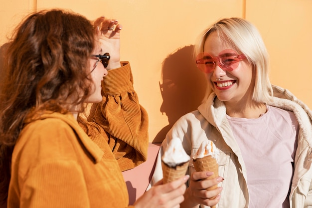 Free photo medium shot smiley women with ice cream