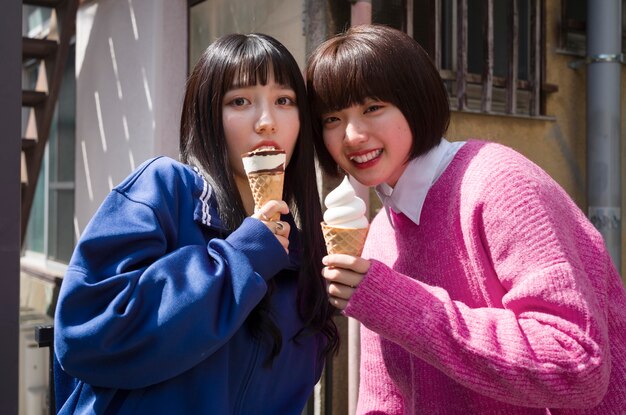 Medium shot smiley women with ice cream