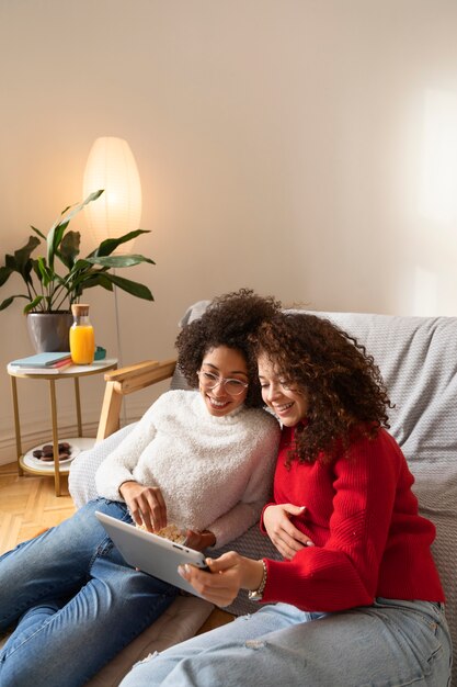 Medium shot smiley women with tablet