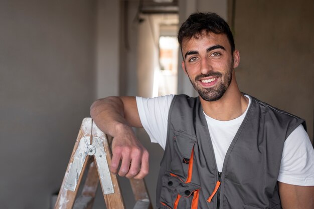 Medium shot smiley worker wearing vest