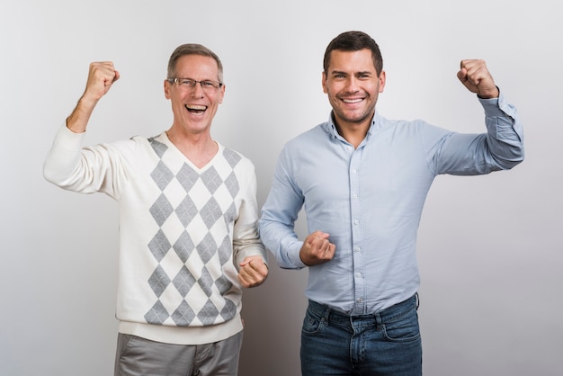 Medium shot of smiling father and son