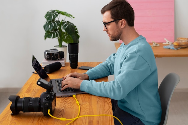 Medium shot specialized photographer working in studio