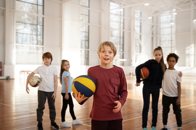 Medium shot sporty kids at gym