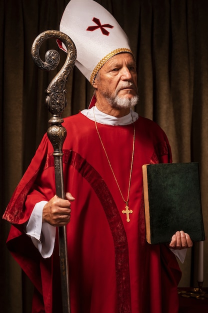 Free Photo medium shot st nicholas holding book and cane