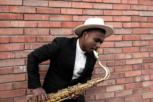 Free Photo medium shot talented jazz man playing saxophone