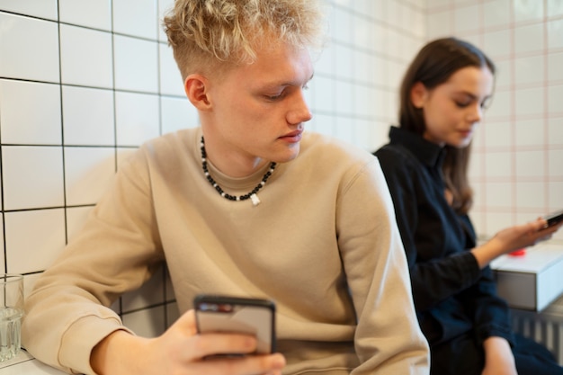 Medium shot teenagers with devices