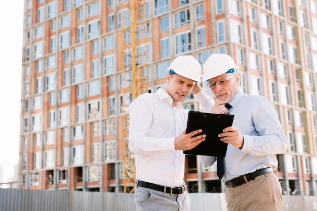 Medium shot thinking men with helmets