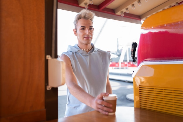 Free photo medium shot transgender holding coffee cup