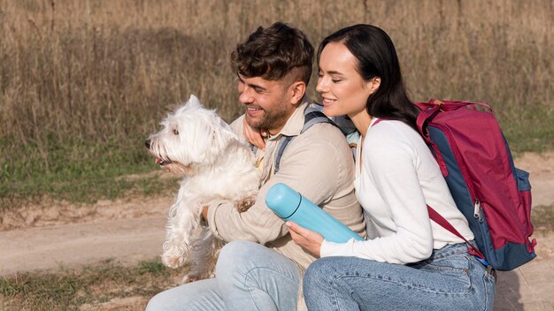 Medium shot travelers holding dog