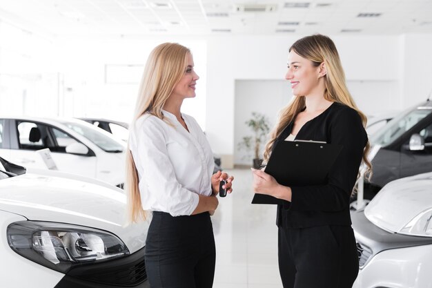 Medium shot of two blonde women looking at each other