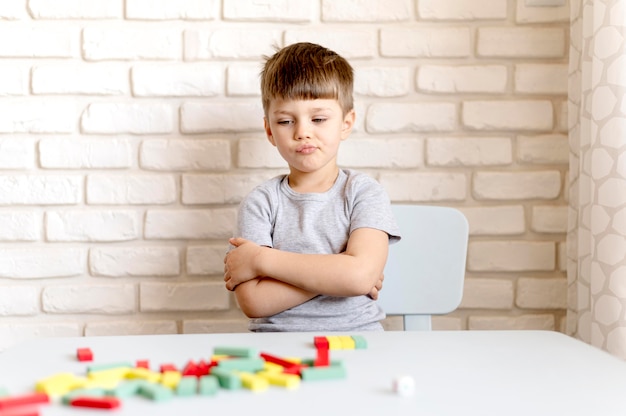 Free Photo medium shot upset boy on chair