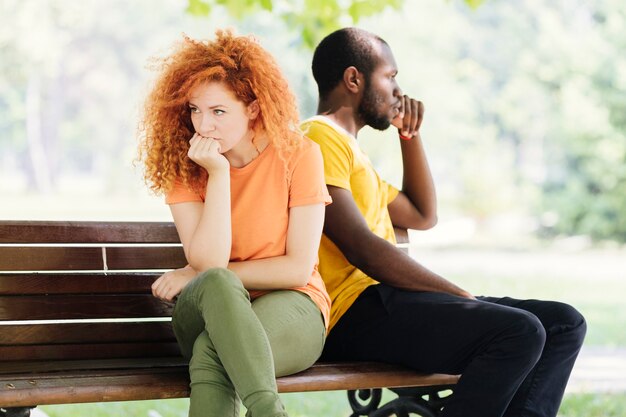 Medium shot of upset couple in the park