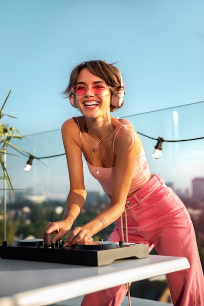 Free photo medium shot woman being dj at party