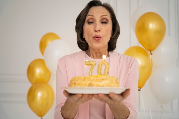 Medium shot woman blowing candles