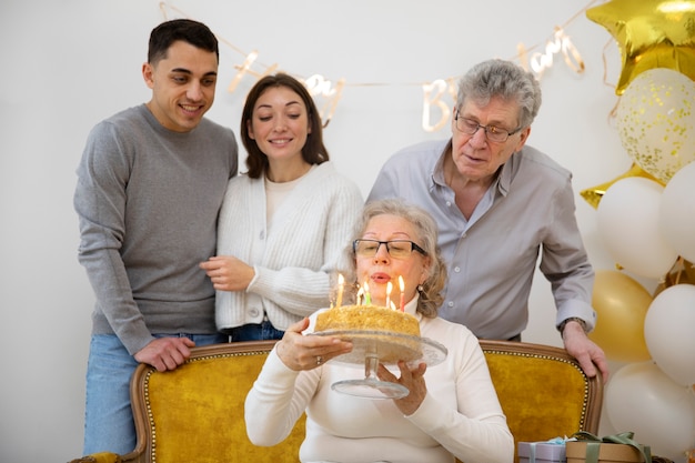 Medium shot woman blowing candles