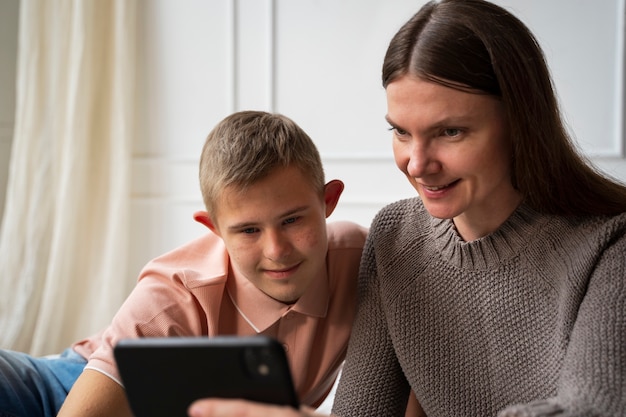 Medium shot woman and boy with smartphone