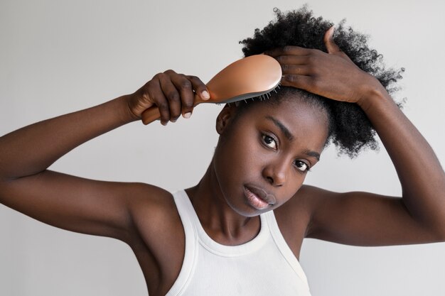 Medium shot woman brushing hair