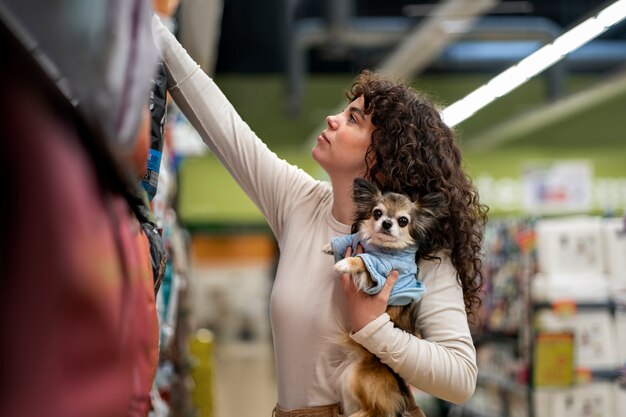 Medium shot woman buying dog food